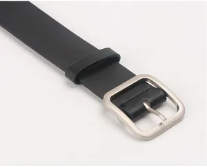 Close-up of black PU leather belt texture with a brushed metal square buckle for women