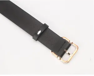 Detailed macro view of black textured PU leather belt with square gold metal buckle