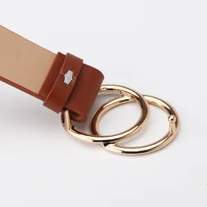 Brown leather women's belt featuring a double interlocking gold ring buckle on white background