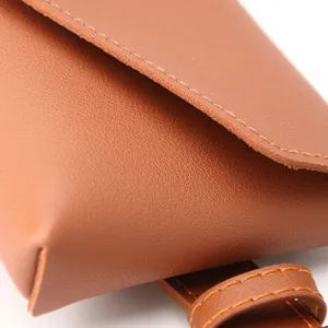 Brown leather waist bag for women featuring fine pebble texture and contrast stitching