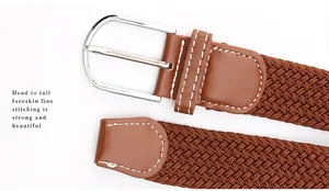 Detail of brown braided elastic belt showing white precision stitching and leather finish