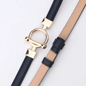 Women's slim black leather belt with a polished gold round buckle for dresses