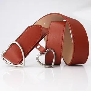 Brown leather belt for women featuring a stylish silver heart-shaped metal buckle