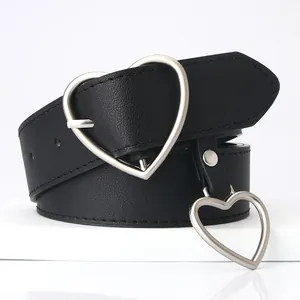 Black leather belt for women featuring a large silver heart buckle and a matching heart pendant