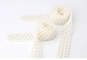 Close-up of elegant woven imitation pearl belt with textured diamond mesh design