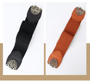 Close-up of vintage wide elastic waist belts with antique bronze hollowed buckles