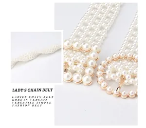 Detailed macro view of woven faux pearl waist chain belt with a golden alloy buckle
