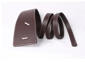 Macro shot of dark brown leather belt with white stitching and textured lychee pattern