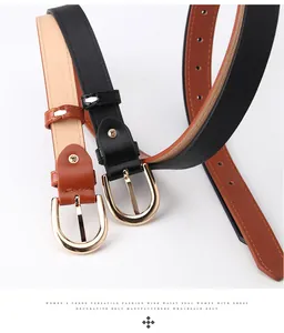 Detail of slim black and caramel faux leather belts with gold horseshoe buckles