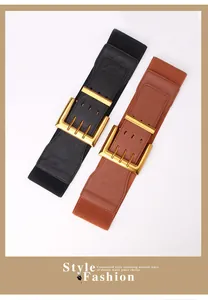 Detail of wide elastic waist belts in black and brown with polished gold buckle