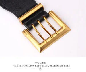 Macro shot of wide black pebbled leather belt with three-pin square gold metal buckle