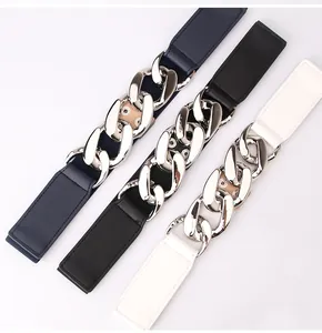 Close-up of elastic waist belts in blue, black, and white with chunky silver metal chains