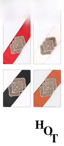 Detail view of vintage carved buckle elastic waist belts in red, white, black, and camel