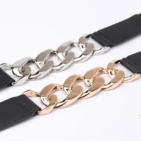 Close-up of thick gold and silver metal chain links on black punk style wide belts