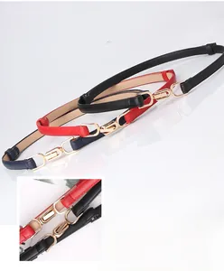 Detailed view of women's skinny belts in red, black and blue with gold alloy buckles
