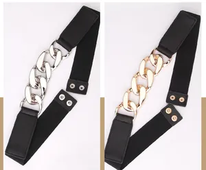 Detail of elastic waist belt with chunky gold and silver chain and snap buttons