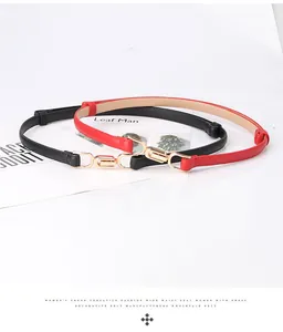 Close-up of red and black skinny belts with interlocking gold buckles for dresses