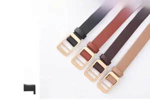 Detail shot of four slim leather belts in black, brown, and tan with gold buckles
