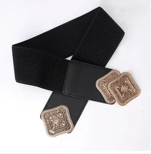 Detail of vintage gold geometric buckles on black elastic wide belt for women dresses
