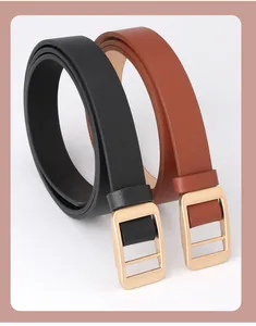 Close-up of black and brown leather belts with minimalist gold rectangular buckles