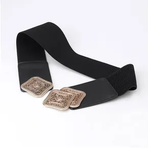 Detail of vintage wide elastic belt featuring golden filigree buckle on black band