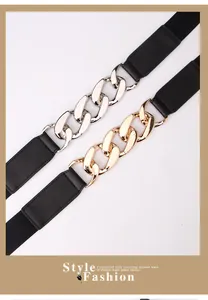 Close-up of chunky gold and silver chain buckles on elastic punk style waist belts