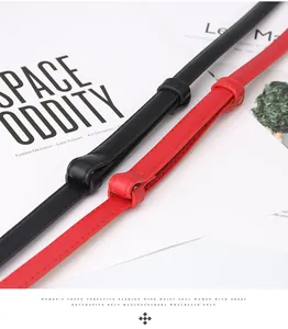 Detailed close-up of slim black and red fashion belts with fine stitching for dresses