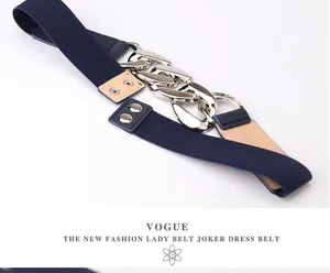Detail of navy blue elastic waist belt featuring a chunky polished silver chain buckle