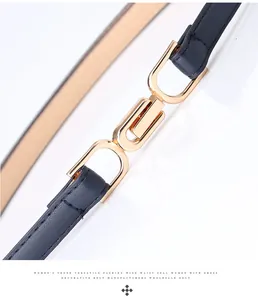 Macro shot of navy leather belt featuring golden U-shaped interlocking metal buckle