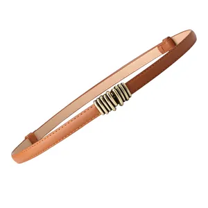 Slim tan leather belt for women featuring a vintage brass-tone textured metal buckle