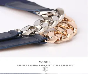 Detail of chunky metal chain buckle on dark blue elastic waist belt for dresses