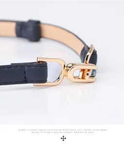 Macro detail of dark blue slim leather belt showing golden buckle and fine stitching