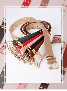 Detail of colorful faux leather belts with golden double-pin buckles and metal eyelets