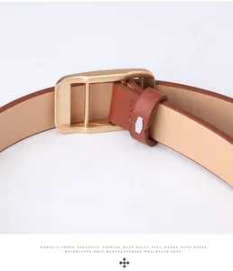 Detail of reddish-brown wide leather belt showing a golden metal buckle and smooth texture