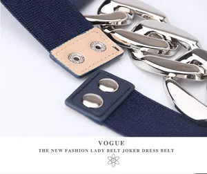 Detail of navy blue elastic waist belt with chunky silver metal chains and double snaps