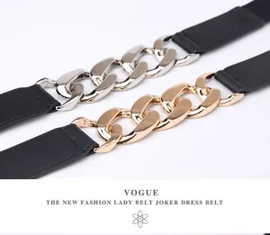 Detailed close-up of chunky gold and silver chain belts with black elastic band