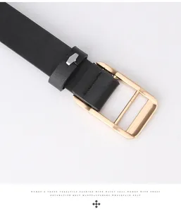 Close-up of black litchi pattern leather belt with polished gold rectangular buckle