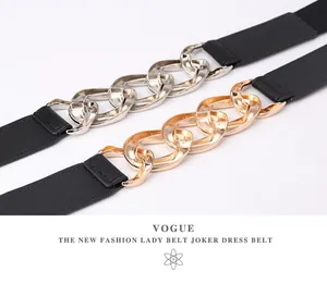 Detail of trendy punk belts with thick gold and silver metal chains on black bands