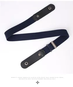 Macro detail of navy elastic web belt with black leather ends and silver metal buckle