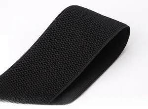 Detail of black elastic wide belt featuring textured corn grain pattern for women