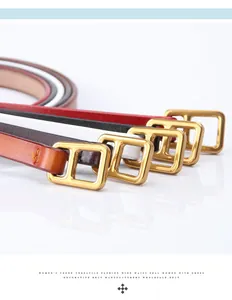 Close-up of four thin cowhide belts in black, brown, white, and red with gold buckles
