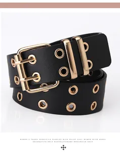 Detail of black wide double-grommet belt featuring gold eyelets and square double-prong buckle