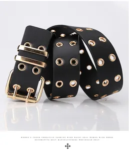 Detail of black leather corset belt with double row of gold eyelets and dual pin buckle