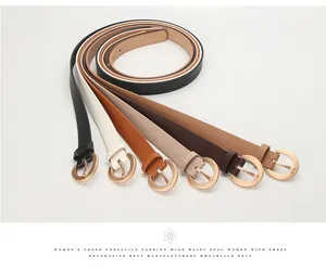 Flat lay of women's thin leather belts in six colors with gold round metal buckles