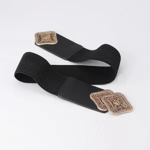 Women's vintage wide elastic waist belt with engraved gold buckle on white background