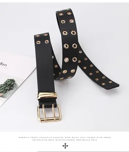 Close-up of black PU leather belt with double row gold eyelets and vintage metal buckle