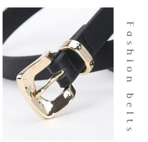 Close-up of minimalist black leather belt with a textured gold square buckle