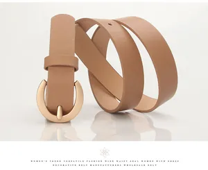 Detailed view of camel faux leather wide belt with polished gold round buckle