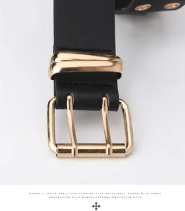 Close-up of double-tongue golden buckle on black leather belt with multi-eyelet design