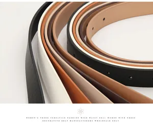 Macro shot showing multiple minimalist thin leather belts in classic black, white, and brown